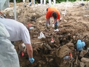 Workers examine remains at a mass grave in eastern Bosnia in 2004. (Credit: Polargeo)