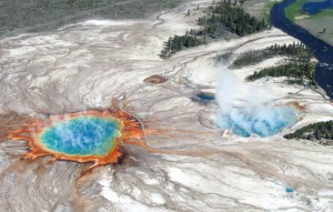 An aerial flight over Yellowstone's Midway Geyser Basin in 2004 shows Grand Prismatic Spring and  Excelsior Geyser Crater, which drain into the nearby Firehole River. A giant underground reservoir of hot and partly molten rock feeds the volcano at Yellowstone National Park.  It has produced three huge eruptions about 2.1 million, 1.3 million and 640,000 years ago.  Credit: USGS