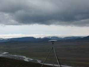 This global positioning satellite receiver is part of Iceland’s network of 62 such receivers that geoscientists are using to detect movements of the Icelandic crust that are as small as one millimeter per year. Langjökull glacier is in the background. Credit: Richard A. Bennett/ University of Arizona Department of Geosciences. 