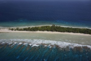 Aerial photograph of Kwajalein Atoll in the Marshall Islands showing its low-lying islands and coral reefs. A new study gives guidance to coastal managers to assess how climate change will affect a coral reef’s ability to mitigate coastal hazards. Credit: Curt Storlazzi/USGS