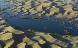 Scientists followed the journey of water through the Tarim Basin from the rivers at the edge of the valley to the desert aquifers under the basin. They found that as water moved through irrigated fields, the water gathered dissolved carbon and moved it deep underground. Credit: Yan Li