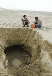 Researchers gathered groundwater flowing under the desert sands. The amount of carbon carried by this underground flow increased quickly when the Silk Road, which opened the region to farming, began 2,000 years ago. Credit: Yan Li